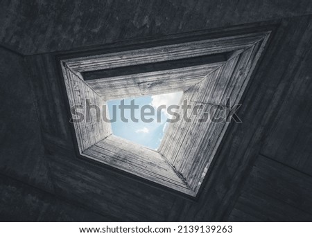 Light well of concrete brutalist building. Looking up at the sky through pentagonal shaped figure.   Royalty-Free Stock Photo #2139139263