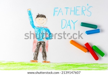 The father in the red superhero cape is depicted in a children's drawing. The inscription father's Day.