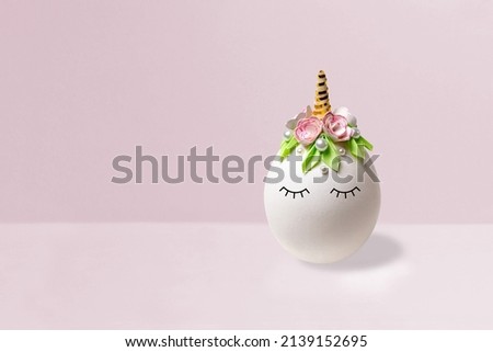 Cute homemade unicorn made of egg. Creative Easter decor in kawaii style. Minimal Easter concept