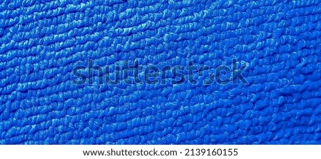 The texture of the cloth is blue (macro)