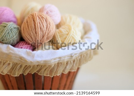 balls of knitting threads in a basket