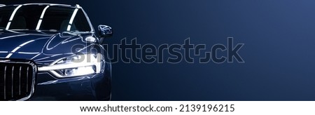 Black modern car closeup on black background. Royalty-Free Stock Photo #2139196215