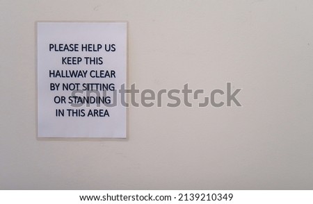 Hallway traffic sign. Please help us keep the hallway clear by not sitting or standing in this area.