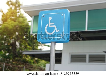 Blue sign with symbol of person sit on wheelchair. Parking for disability persons sign. Service as privileges for handicap to park car at public park or gas station.                  