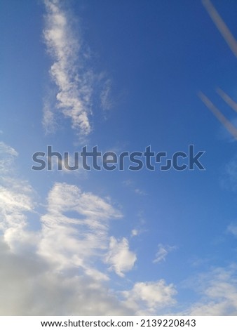 Picture of a sky full of clouds and some bathrooms flying
