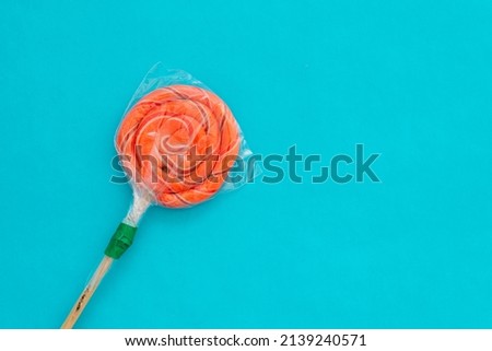 Candy lollipop on blue background. Candy lollipop isolated on blue background.