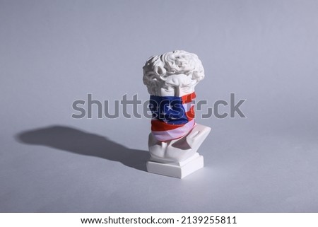 David bust with usa flag on his face against gray background. Patriotism. Minimal still life