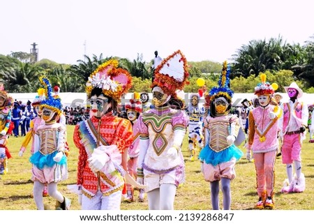 Masked masquerade dancers in position to march during a festival in West Africa
