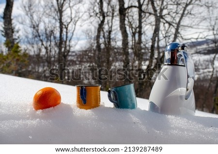 Oranges and coffee cups in the Easter snow