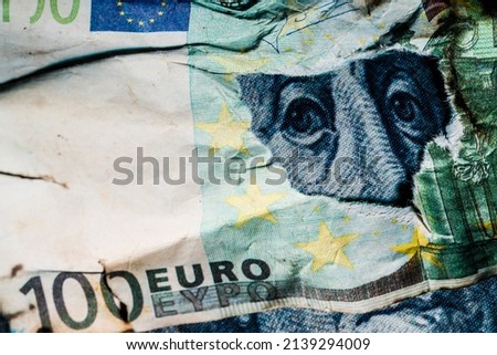 Benjamin Franklin's face peeking out of a hole in a 100 euro banknote. High quality photo Royalty-Free Stock Photo #2139294009