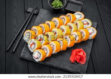 Sushi set. Philadelphia roll, california, unagi, black dragon with fresh ingredients on black background. Sushi menu. Japanese food.