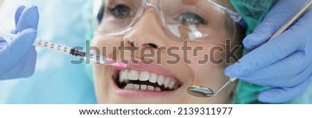 A woman is given an injection before a dental procedure Royalty-Free Stock Photo #2139311977