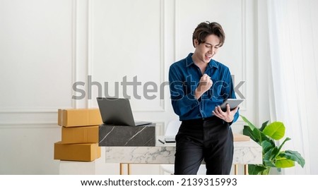 Startup small business entrepreneur SME, asian man receive order on phone. Success young Asian small business owner home office, online sell marketing delivery, SME e-commerce telemarketing concept Royalty-Free Stock Photo #2139315993