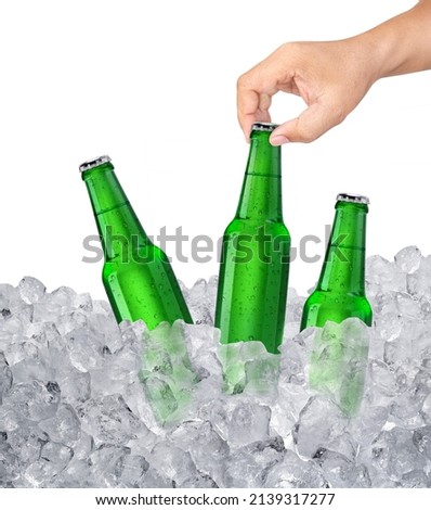 Man holding cold beer bottle in ice cube with chilled beer bottle