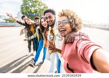 Multiracial friends group taking selfie pic with smartphone outside - Happy young people having fun walking on city street - Friendship concept with guys and girls enjoying summertime day outside Royalty-Free Stock Photo #2139343939