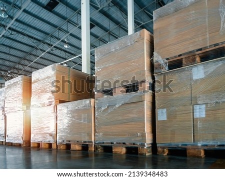 Packaging Boxes Stacked Wrapped Plastic Film on Pallets in Storage Warehouse. Supply Chain. Storehouse Commerce Shipment. Shipping Warehouse Logistics.	
