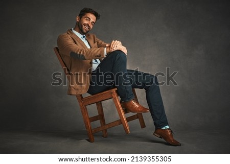 Perfect shoes and outfit, his ready to rule the day. Studio shot of a handsome young man posing against a gray background. Royalty-Free Stock Photo #2139355305