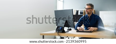 Businessman Using Business Computer In Office Or Workplace Royalty-Free Stock Photo #2139360995