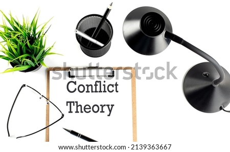 CONFLICT THEORY text on clipboard on the white background