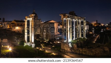 A picture of the Roman Forum at night.