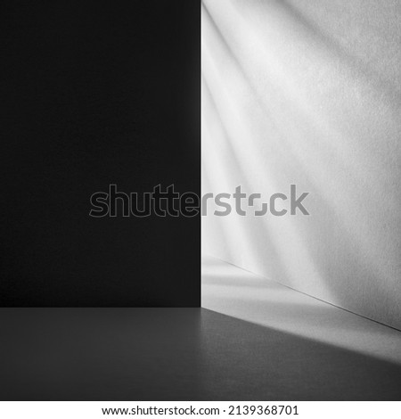 Minimal abstract blue background for product presentation. Organic drop diagonal shadow and rays of light from window on a blue wallpaper