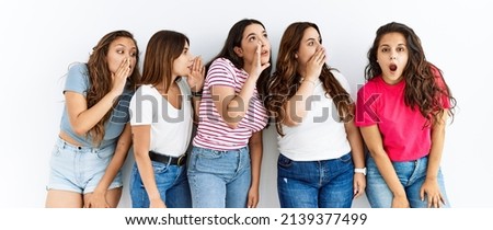 Group of women wearing casual clothes standing over isolated background hand on mouth telling secret rumor, whispering malicious talk conversation 
