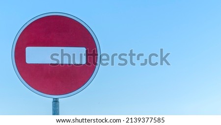 Road sign in the form of a white rectangle in a red circle. No entry. A red round sign warns: entrance forbidden. It is a one way street. Road rules concepts.