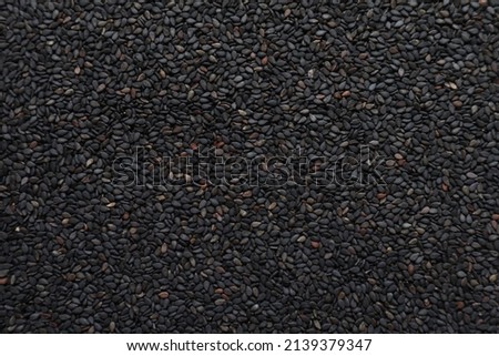 Background image of black sesame seeds laying on a table to inspect bite marks caused by pests destroying seeds being prepared for planting. Organic black sesame seeds destroyed by insect pests
 Royalty-Free Stock Photo #2139379347