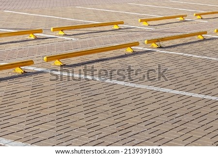 Road yellow barriers and highlighted markings strips for car parking in the mall. Traffic warning symbols. City construction architecture. Urban space. Safety area.