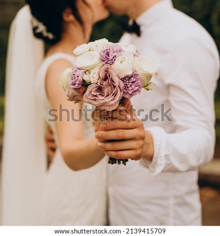 Bridal bouquet of violet and white roses, as well as heleny eucalyptus leaves. Wedding, holiday Royalty-Free Stock Photo #2139415709