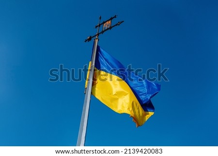 National Yellow-blue Ukrainian flag against the blue sky on mound of Union of Lublin at Castle Hill in Lviv city, Ukraine