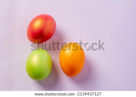 colored painted eggs on a white background