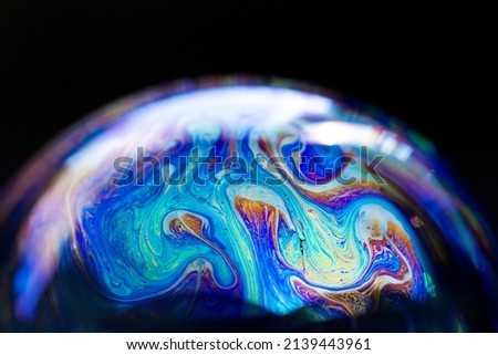 Abstract multicolored pattern, chaotic texture inside of the soap bubble, closeup. High quality FullHD footage. Royalty-Free Stock Photo #2139443961