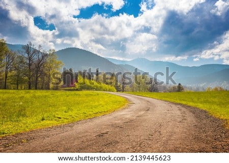 Walking trail in a small village as marvelous moutain view with blue sky, Malenovice, Moravian-Silesian Beskydy. Czech Republic. Royalty-Free Stock Photo #2139445623