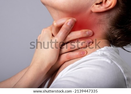 Asthma attack. Woman suffocating, breathing heavily. Sore throat. Hands holding neck with red spot closeup. Respiratory diseases, medicine concept. High quality photo Royalty-Free Stock Photo #2139447335