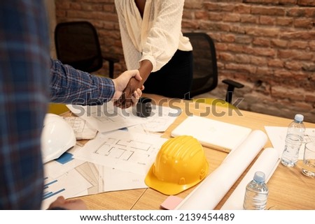 Two businessmen senior and young having business handshake together after success deal and agreement of project merger and acquisition in office