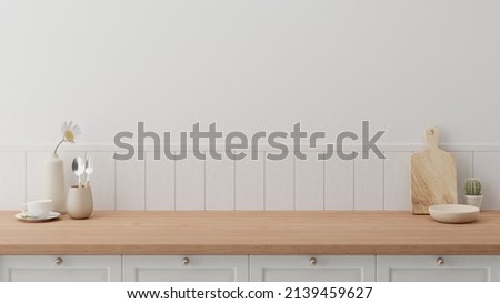 Minimal cozy counter mockup design for product presentation background or branding with bright wood top white counter and wall with vase flower mug chop fork spoon cup. Kitchen interior  Royalty-Free Stock Photo #2139459627