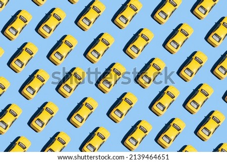 Minimal creative pattern concept with yellow cars on blue background. Aesthetic transportation idea, vivid colors, simple composition.