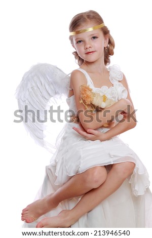 beautiful little angel holding lovely angel doll and sitting on a cloud isolated over white background on Holiday theme