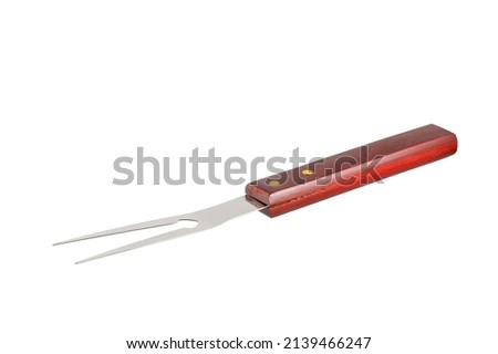 Barbecue fork isolated on white background. Stainless steel grill fork with wooden handle. Close-up Royalty-Free Stock Photo #2139466247
