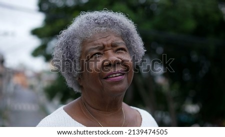 Portrait of an older woman face looking up at sky with HOPE and FAITH