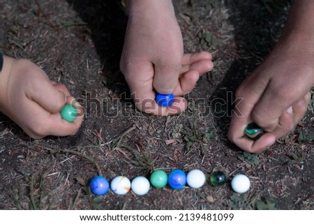 Colored glass balls and marble taw, children's toy. Decoration. Marble taw children enjoy playing