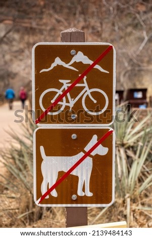 No Mountain Bikes and No Dogs Sign At Trailhead In Zion National Park