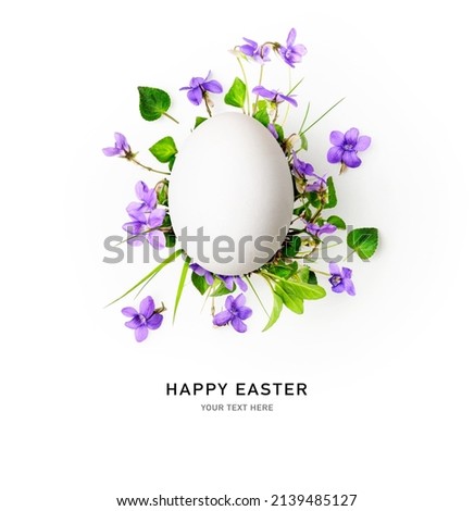 Happy easter egg and spring viola pansy flowers isolated on white background. Floral composition and creative layout. Holiday concept. Top view, flat lay. Copy space 
