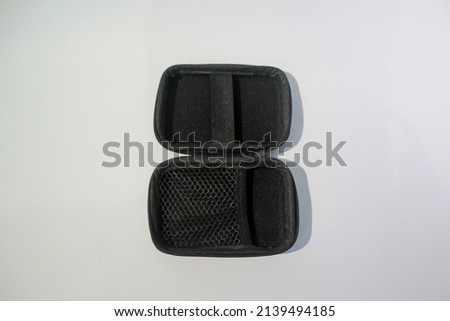 Rectangle holder case for charger and earphone isolated on white background.
