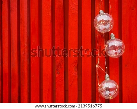 Decorative red wooden wall with ice lamps. design idea for home. New trends in design. Christmas Fair background. happy new year and merry christmas. 