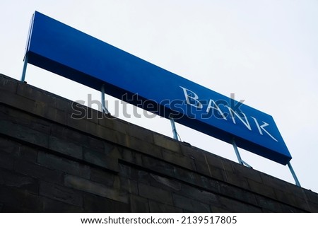 Blank blue square sign on glas wall mockup, sky background. Empty quadratic exterior box for clinic or club mock up. Clear office facade with bank or store lightbox mokcup template.