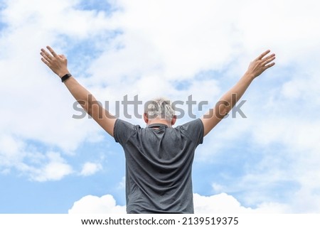 The guy spread his arms towards the sky