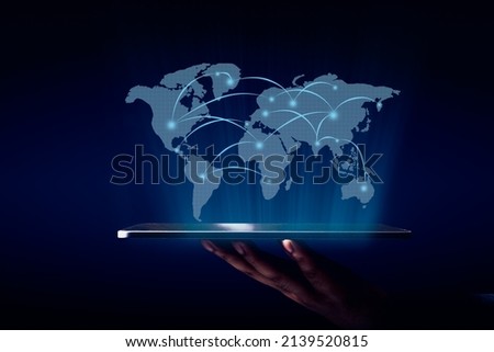 World map hologram with global network showing from the technology tablet over the virtualize screen of world map and business graphic background Royalty-Free Stock Photo #2139520815