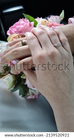 Couple holding hands at wedding day